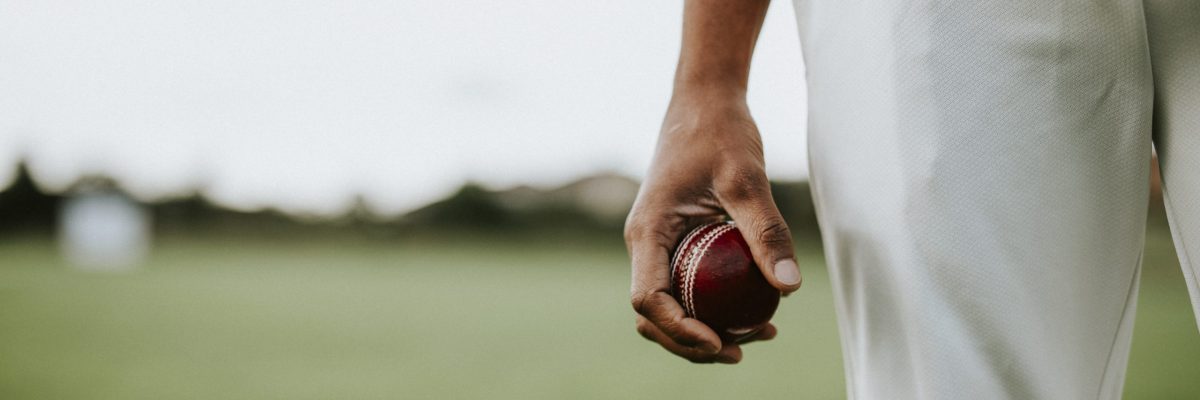 Cricket player holding a leather ball